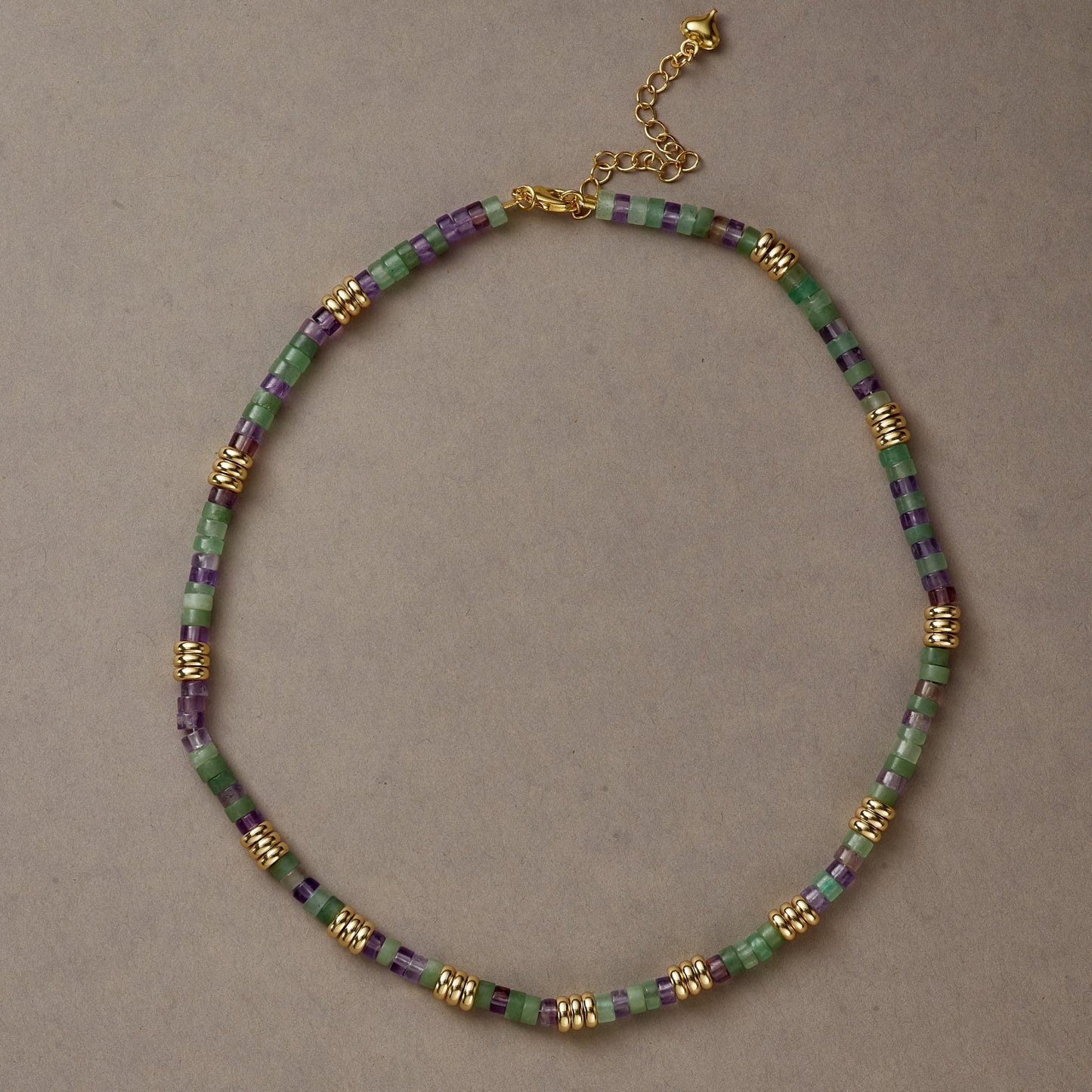 Earth & Spirit necklace styled in a full circle with Green Aventurine and Amethyst beads on a neutral background.