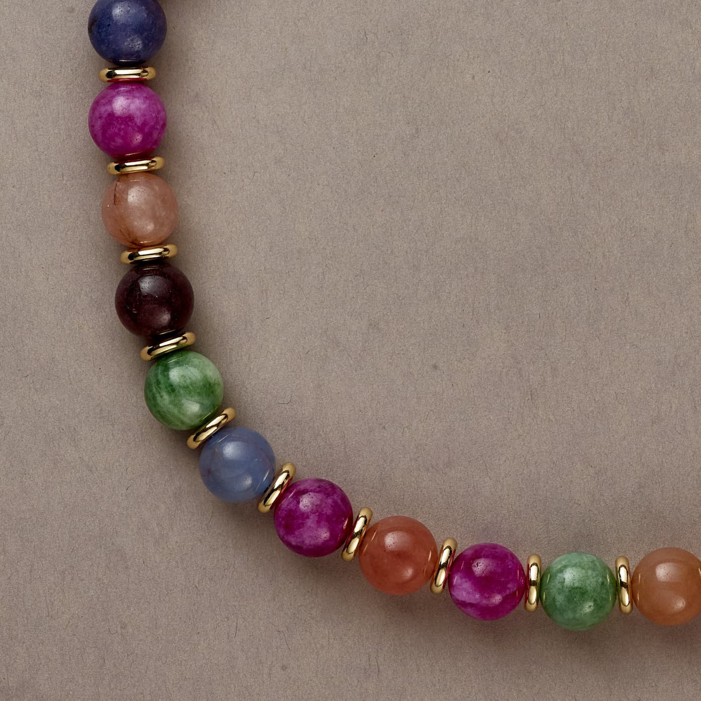 Zoomed-in detail of Rainbow Vibe beads reflecting light, illustrating the radiant and expressive character of the piece.