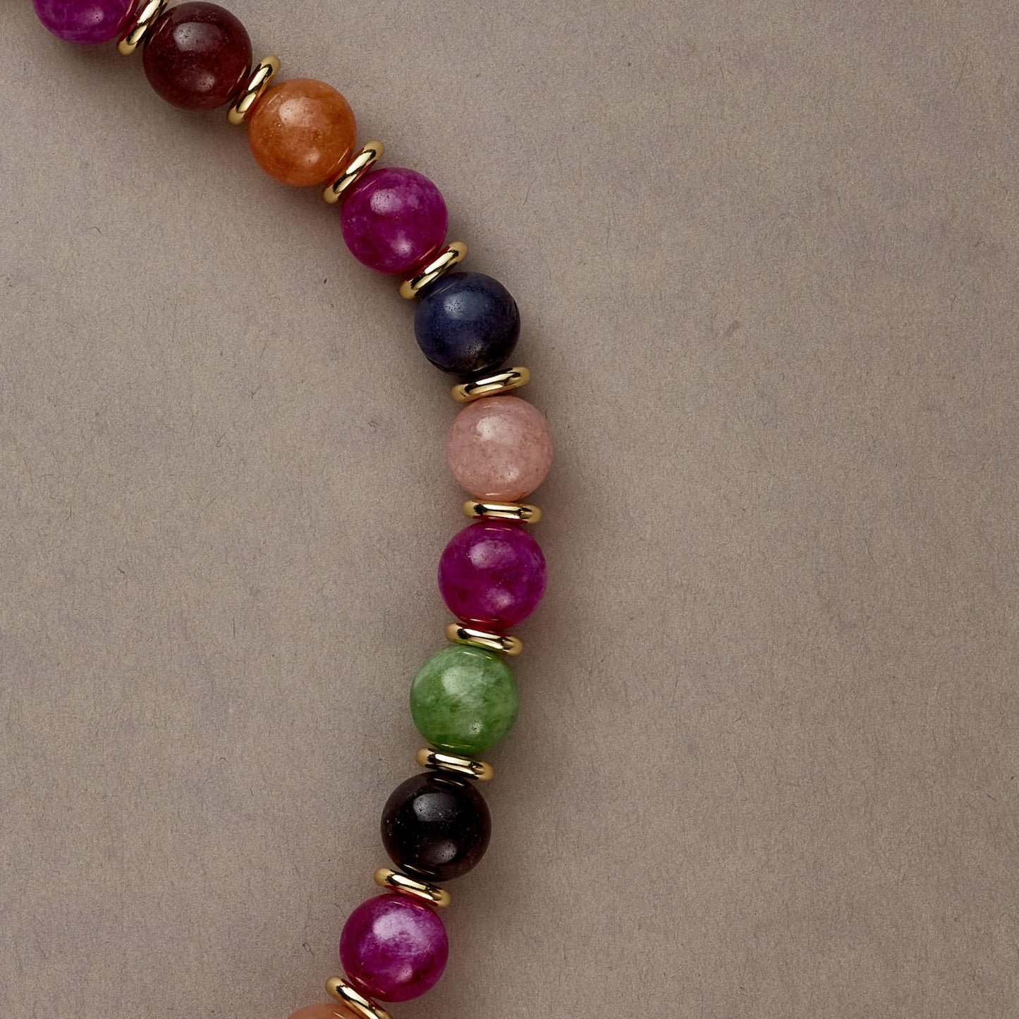 Angled view of Rainbow Vibe necklace curve, highlighting the joyful energy and balance of colors.