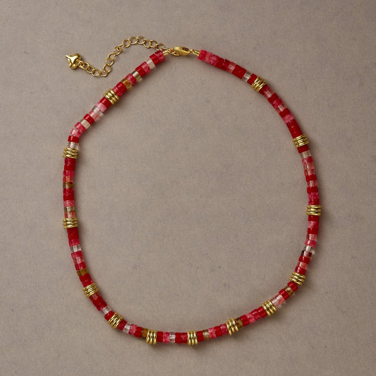 Red Spirit necklace featuring Red Coral and Cherry Quartz beads with gold clasp, arranged in a bold and feminine design.