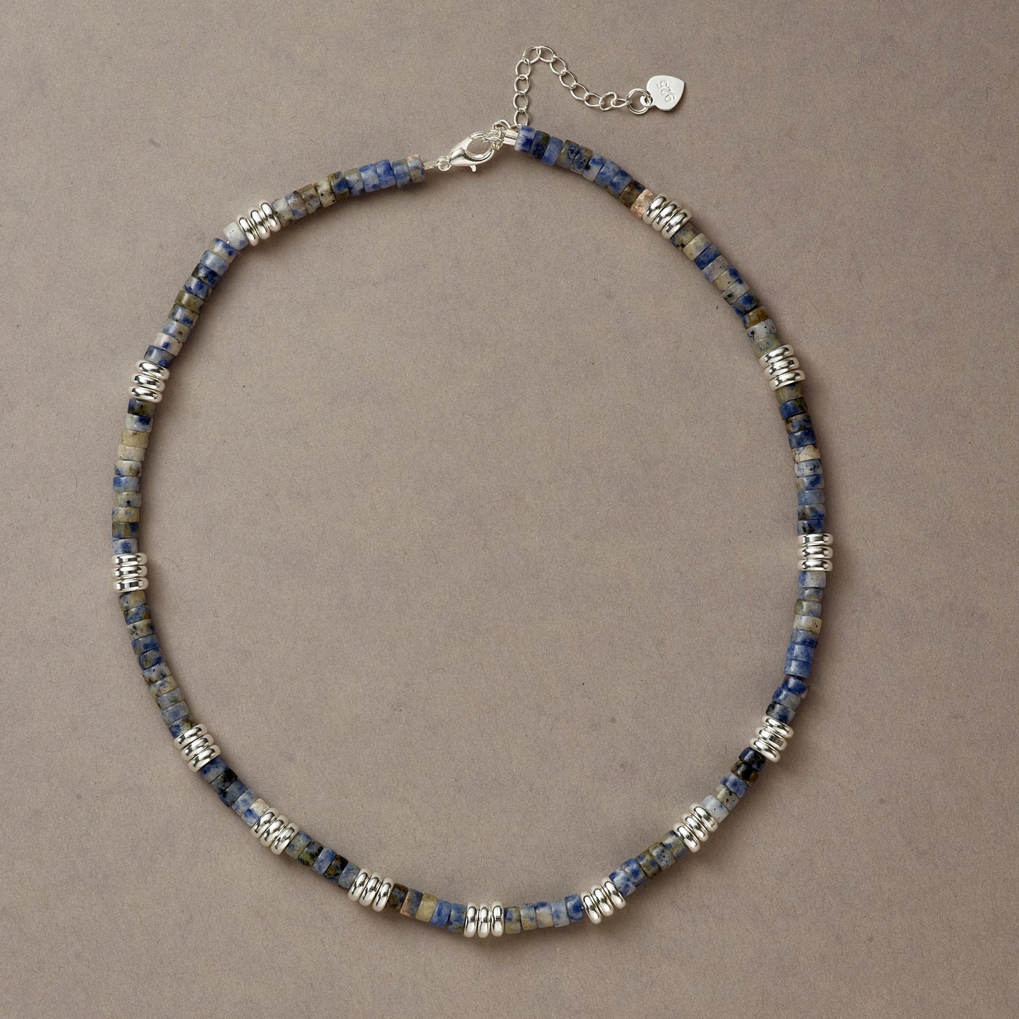 Blue Mind necklace crafted with deep blue Sodalite stones and silver spacers, displayed in a full-circle composition.