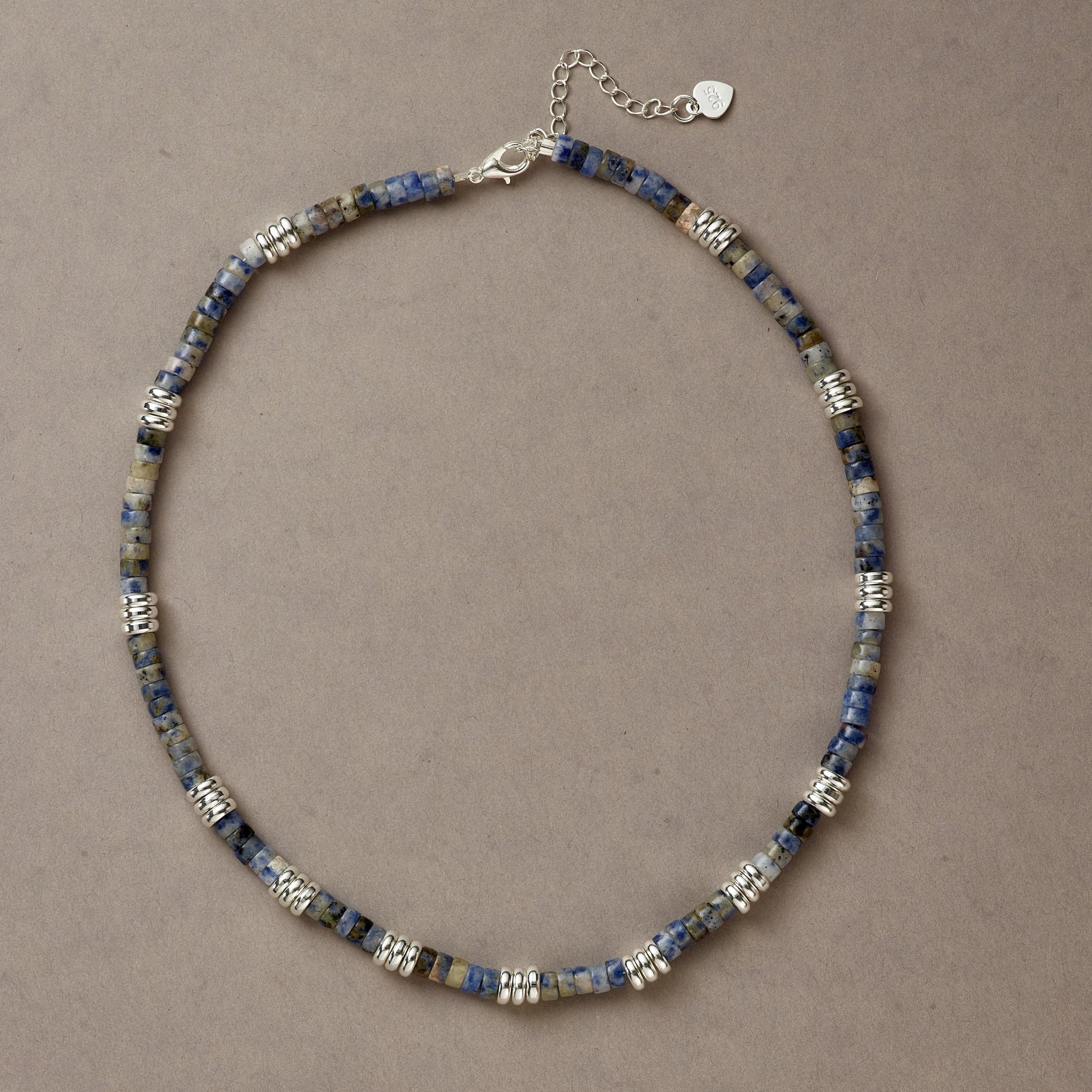 Blue Mind necklace crafted with deep blue Sodalite stones and silver spacers, displayed in a full-circle composition.