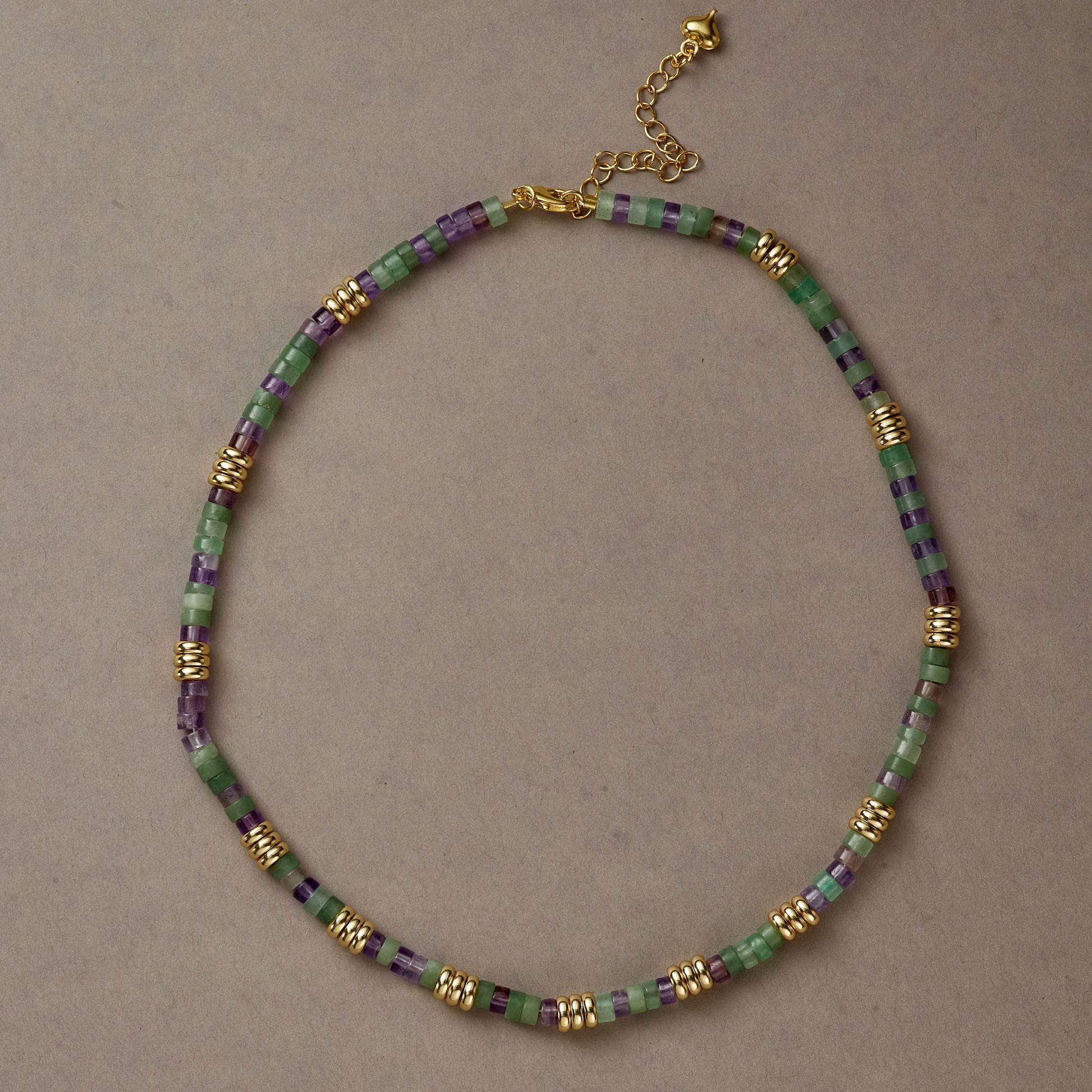 Earth & Spirit necklace styled in a full circle with Green Aventurine and Amethyst beads on a neutral background.