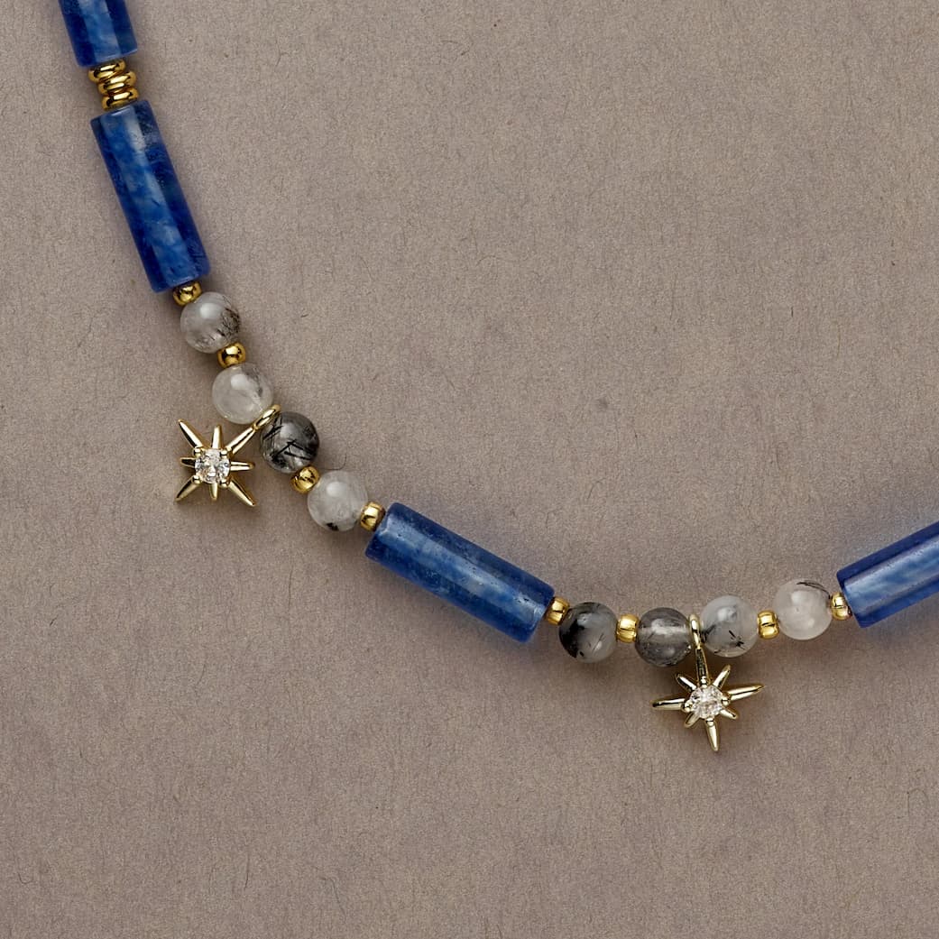 Side shot of Cosmic Blue necklace showing rich navy tones with delicate Tourmaline Quartz for a celestial touch.