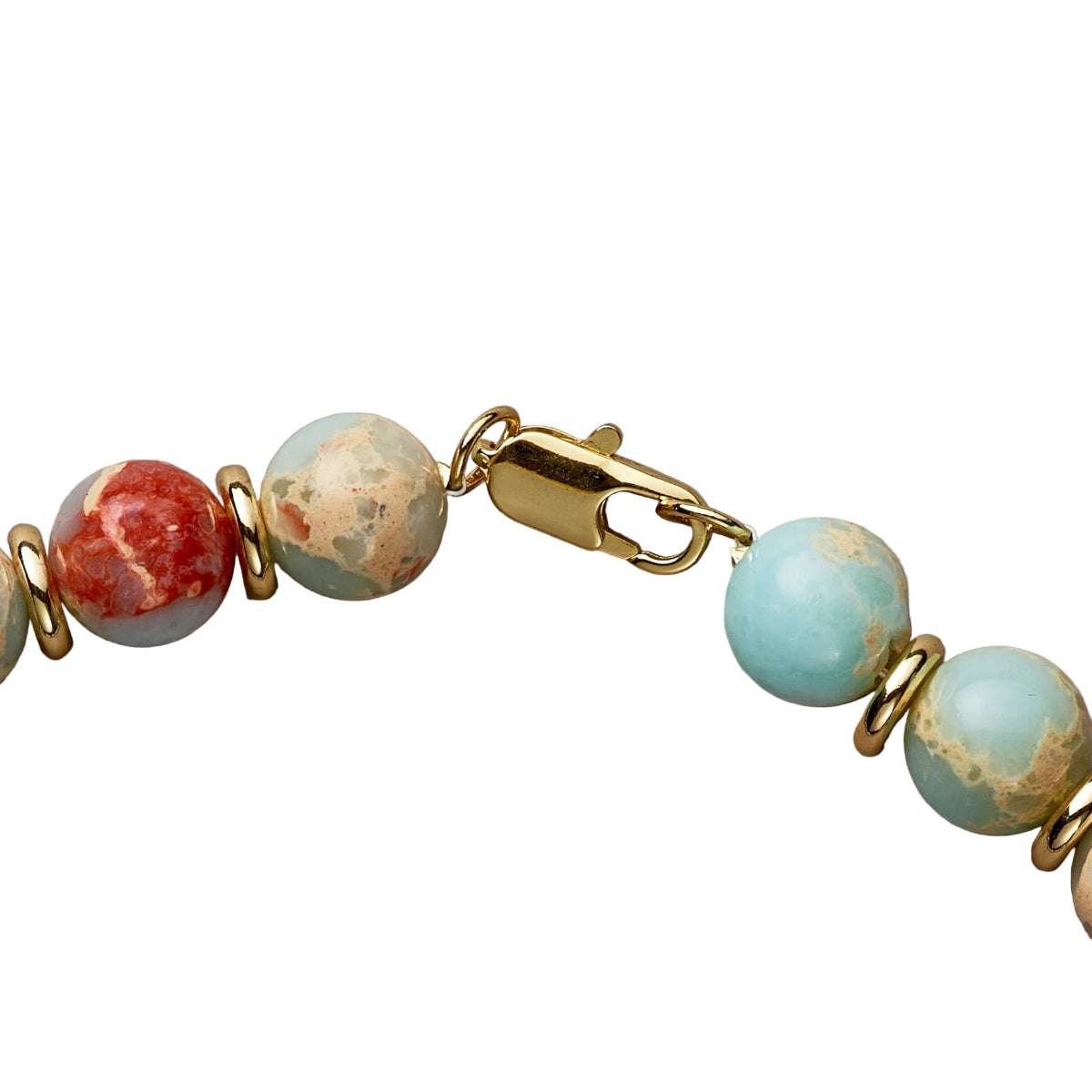 Bracelet with turquoise and red beads on a beige background