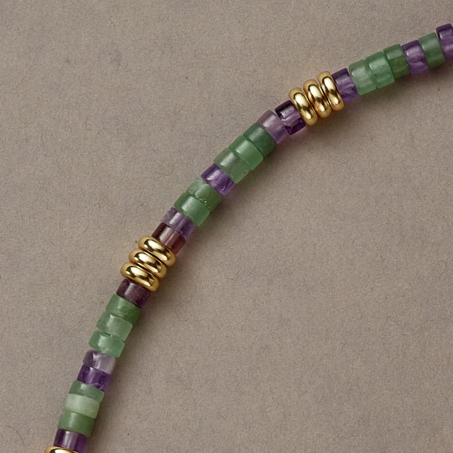 Close-up of Earth & Spirit necklace section with Green Aventurine and Amethyst stones in a gentle curve.