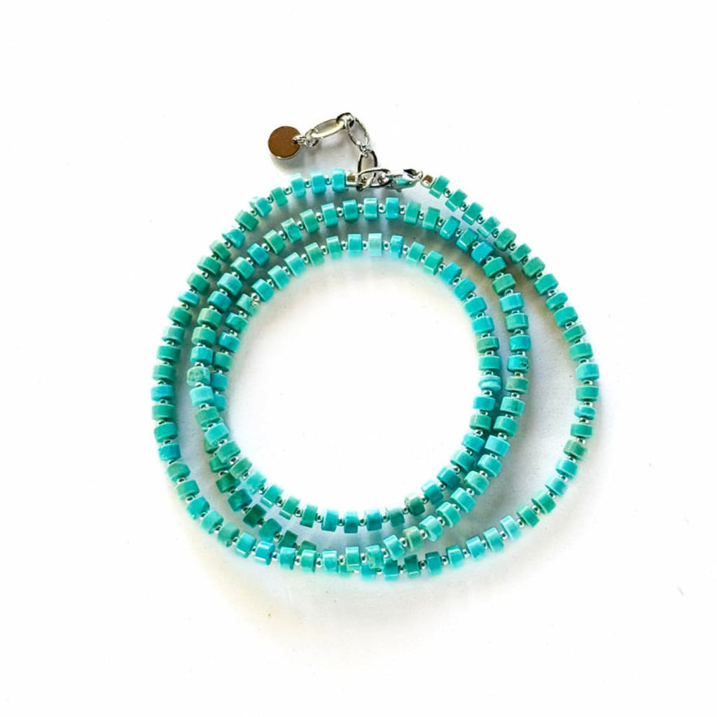 Turquoise beaded necklace on a white background