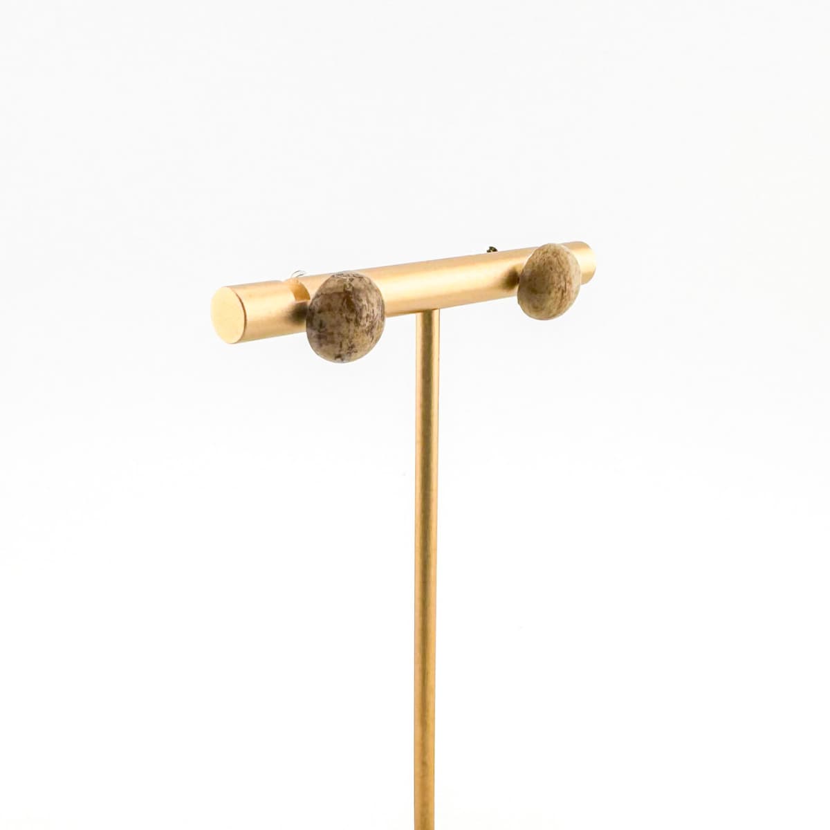 Gold T-shaped jewelry stand on a white background