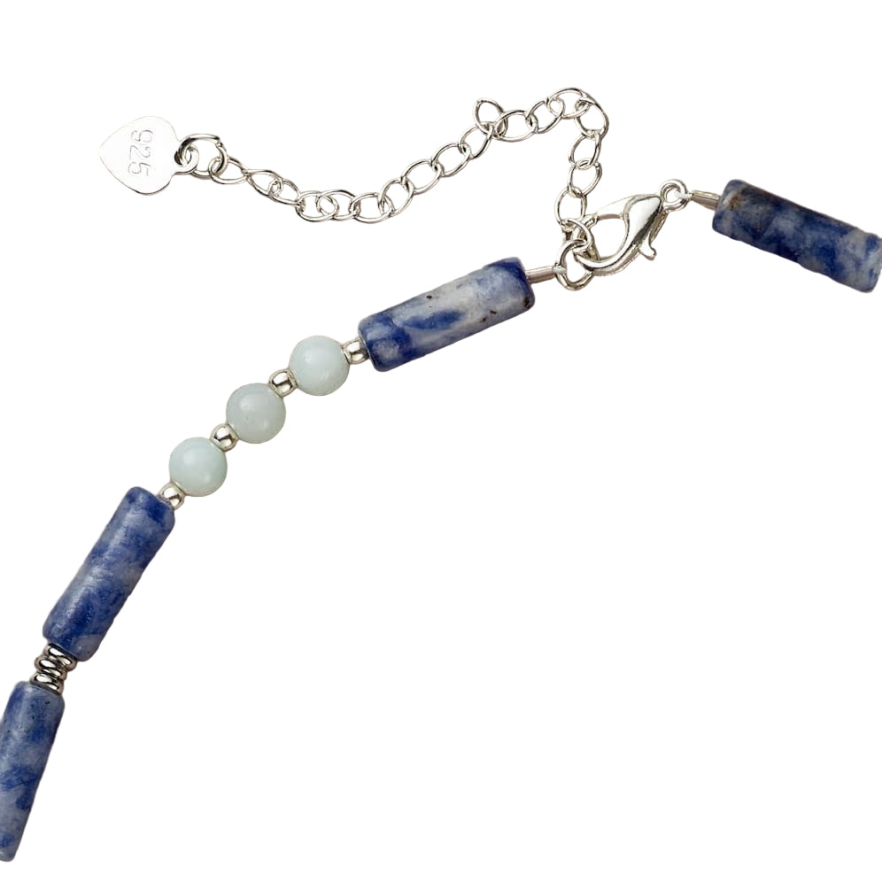 Necklace with blue and white beads on a beige background
