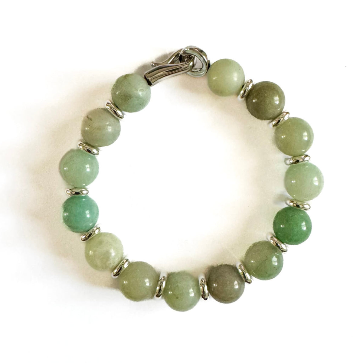 Green beaded bracelet with silver accents on a white background