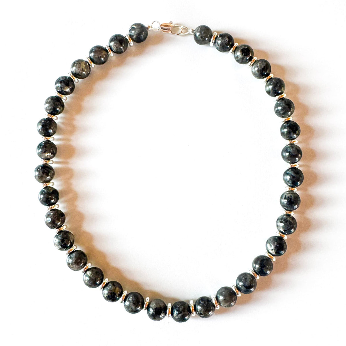Necklace with black beaded design on a white background