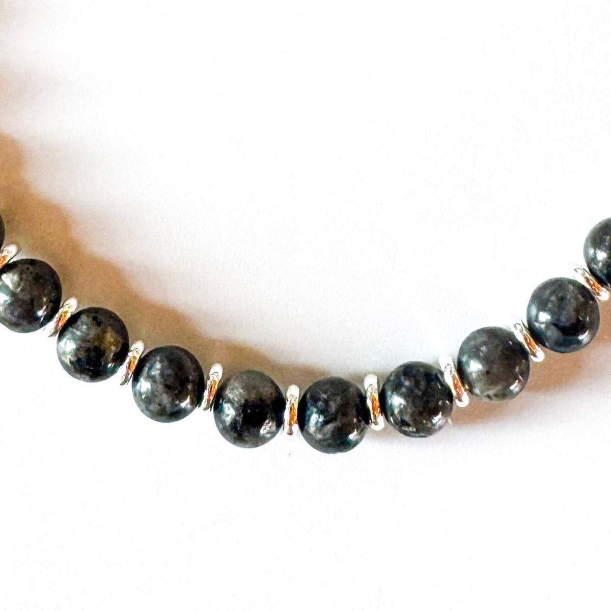 Necklace with dark beads on a white background
