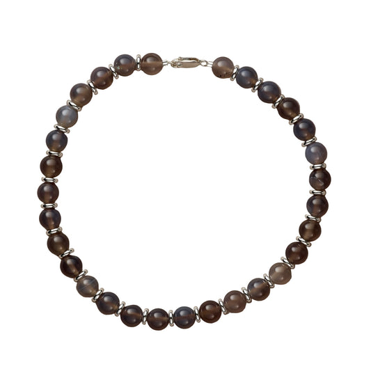 Beaded bracelet with brown and blue beads on a beige background
