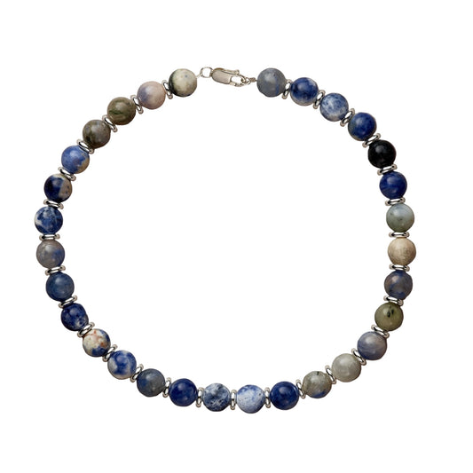 Beaded bracelet with blue, green, and silver beads on a beige background