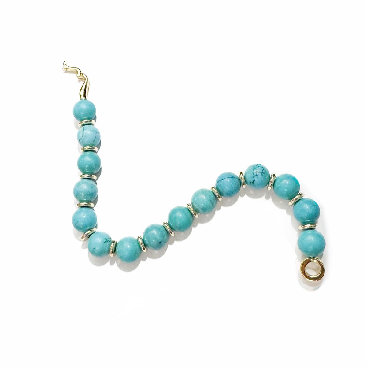 Turquoise beaded bracelet with gold accents on a white background