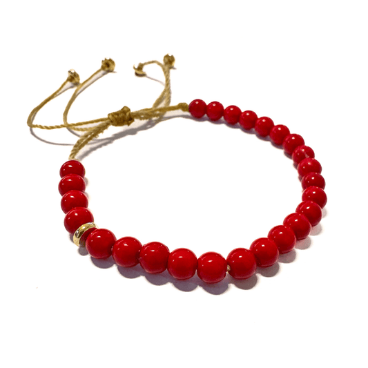 תקריב על צמיד אלמוג אדום של Mella Jewelry על רקע בהיר